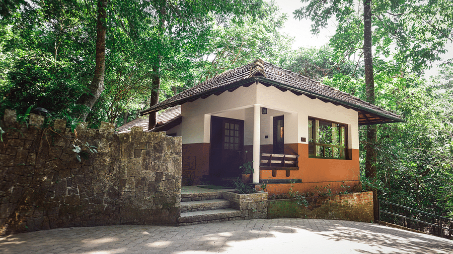 An exterior view of a villa nestled in greenery | Vythiri Resort. Wayanad